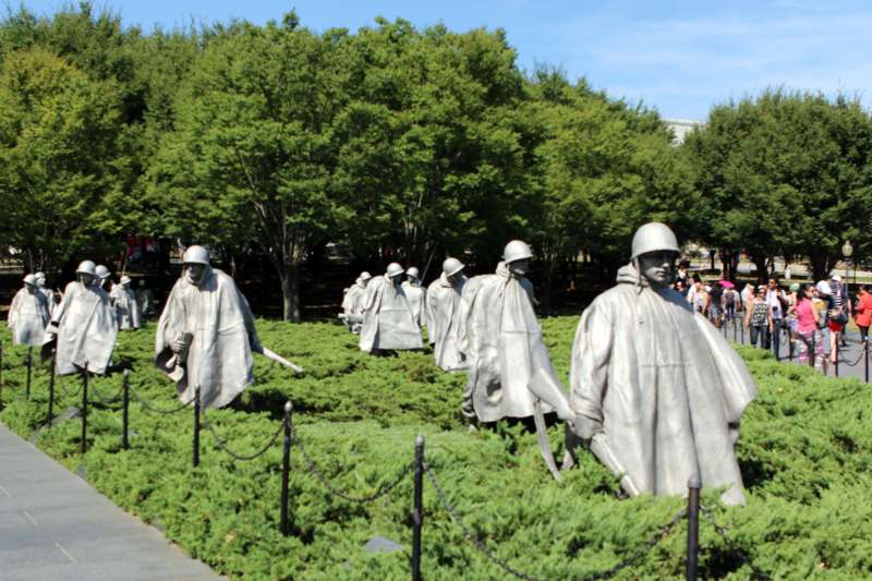 statues of soldiers in a park with Korean War Veterans Memorial in the background