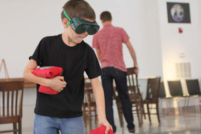 a boy wearing goggles and a red bag