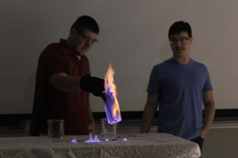 a man lighting a flame on a table