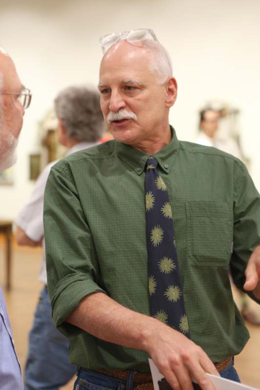 a man in a green shirt and tie