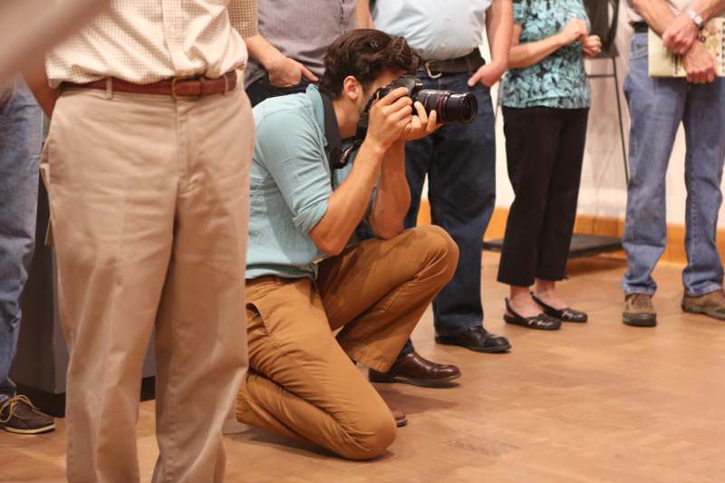 a man kneeling down holding a camera
