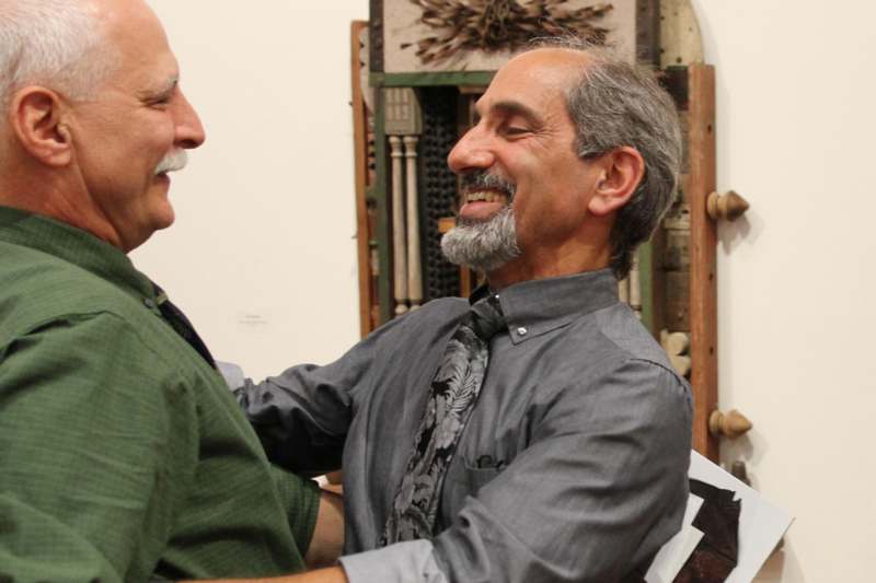 two men smiling at each other