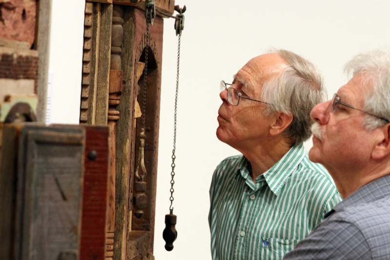 a man looking at a pendulum