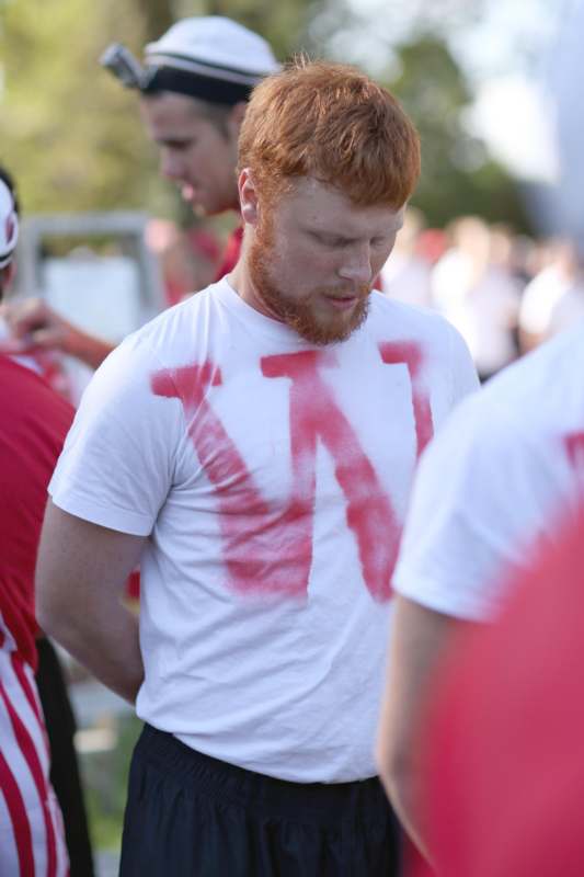 a man with red hair and beard with red text on his shirt