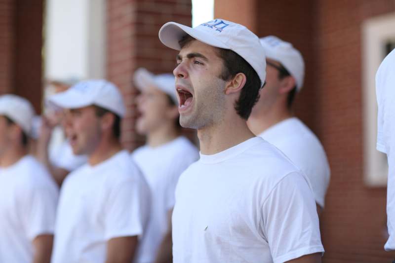 a group of men wearing white shirts and white hats