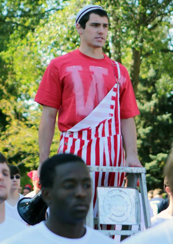 a man in a red shirt and white striped pants