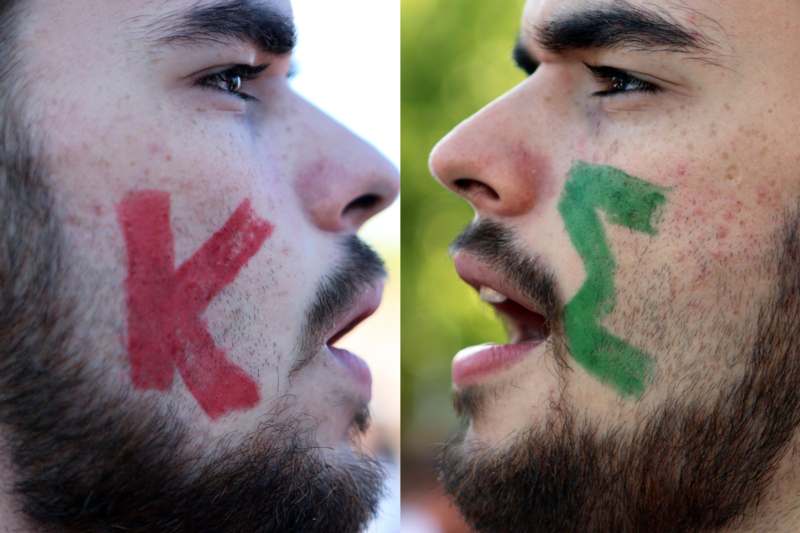 a man with a red x and green x drawn on his face