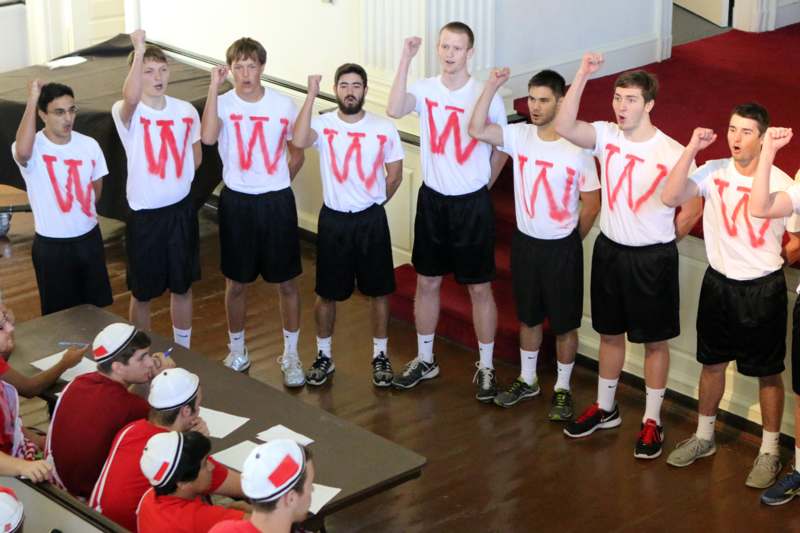 a group of men wearing white shirts with w letters on them