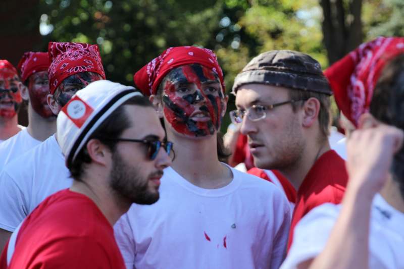 a group of men wearing red bandanas and white shirts
