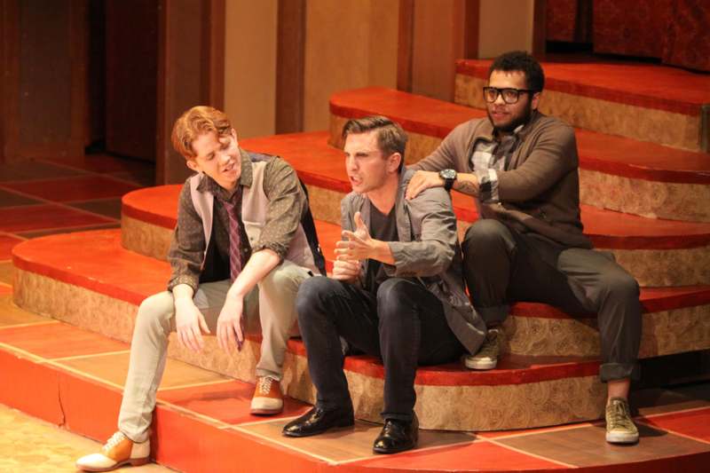 a group of men sitting on a stage