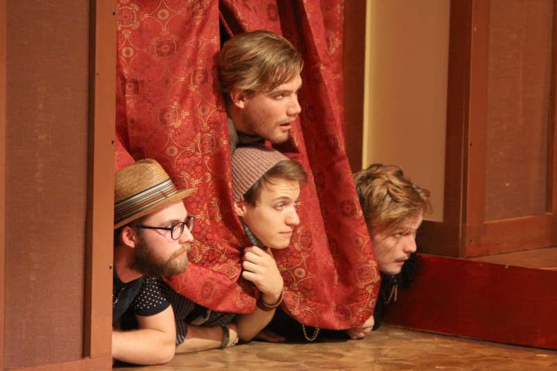 a group of men peeking through curtains