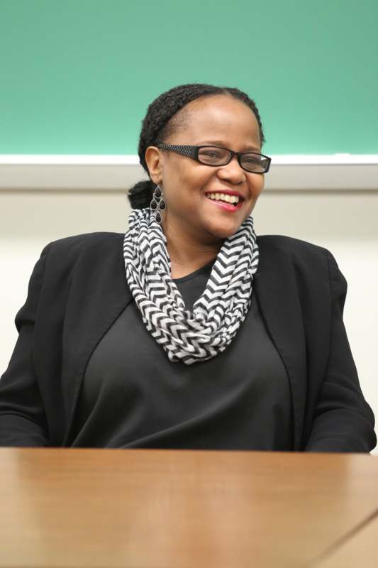 a woman wearing glasses and a scarf