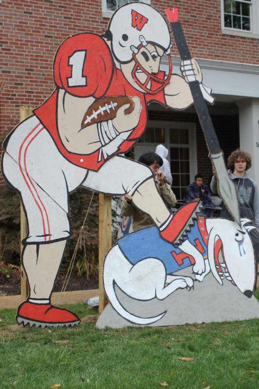 a man holding a baseball bat and a dog