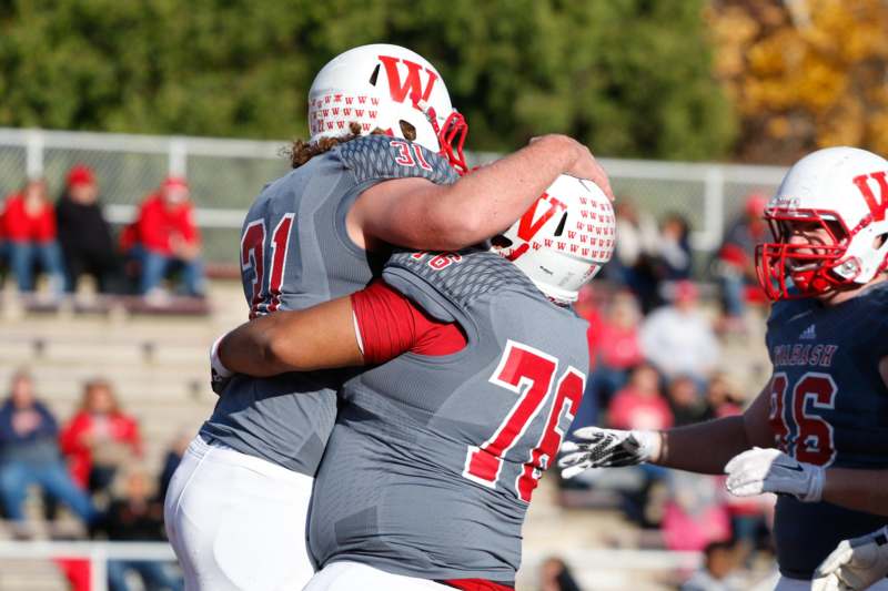 two football players hugging