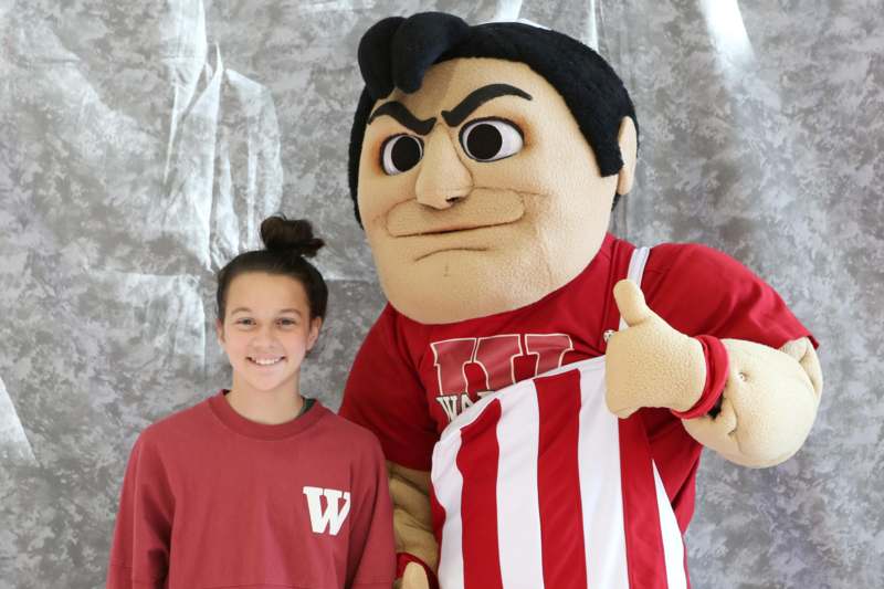 a person posing with a mascot