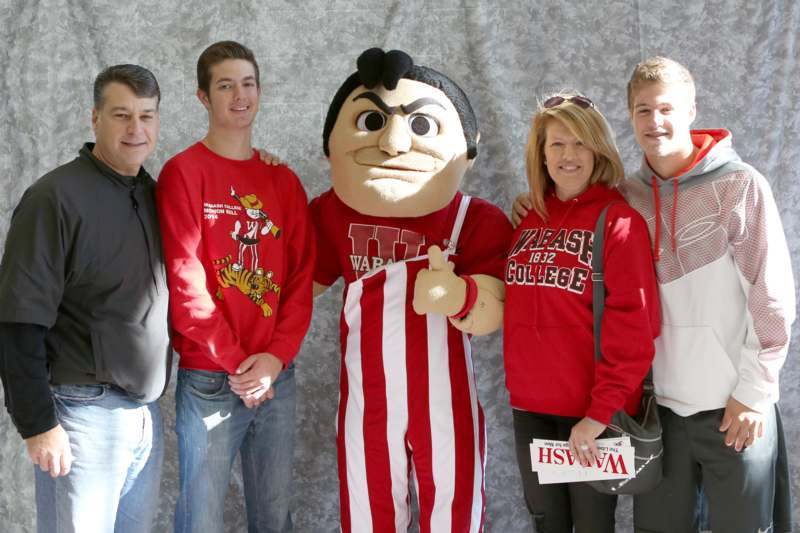 a group of people posing for a photo with a mascot