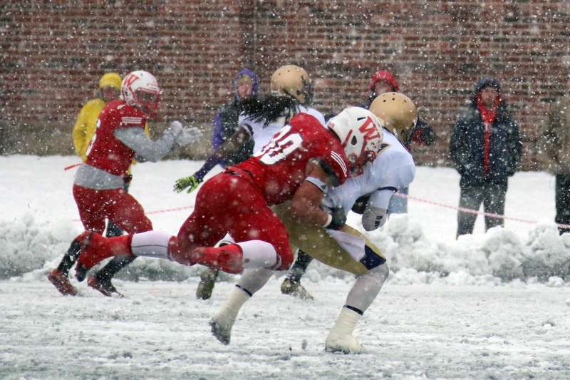 a group of football players in the snow