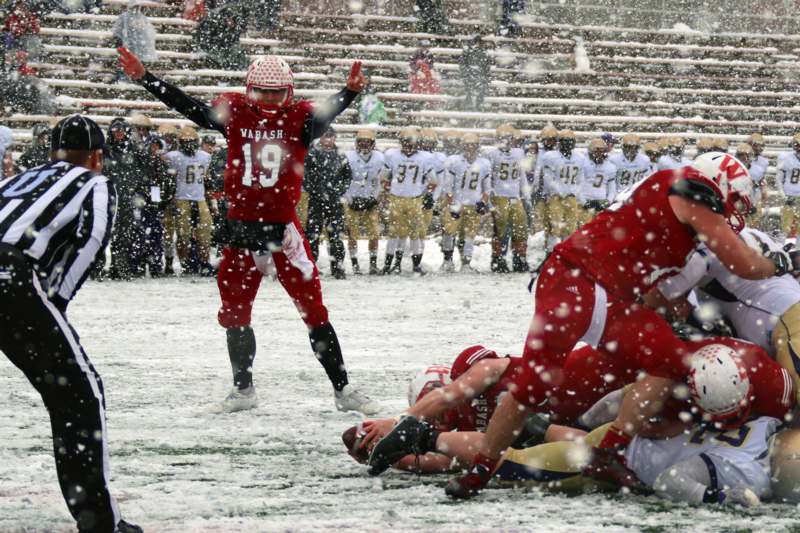 a football player falling from the snow