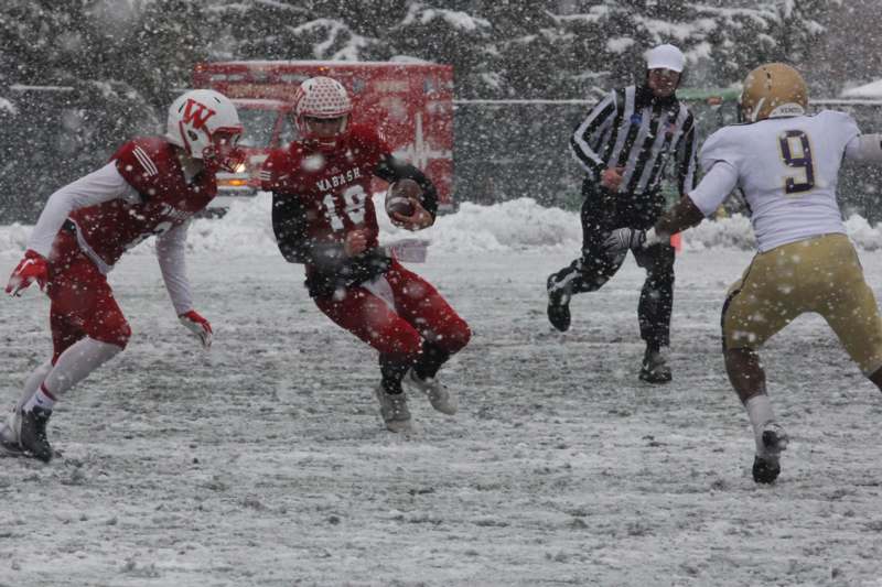 a group of people playing football in the snow