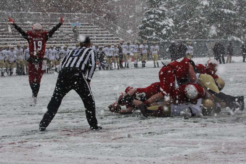 a football players lying on the ground in the snow
