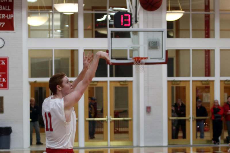 a man in a basketball uniform shooting a basketball