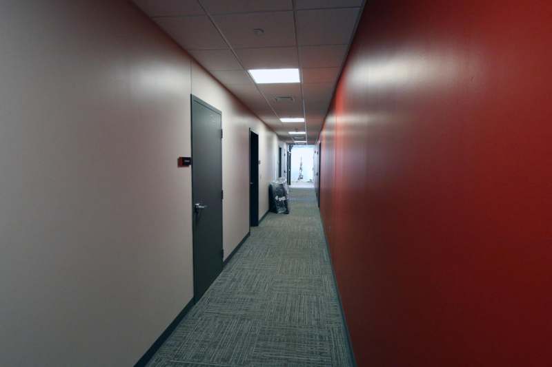 a hallway with red walls and doors