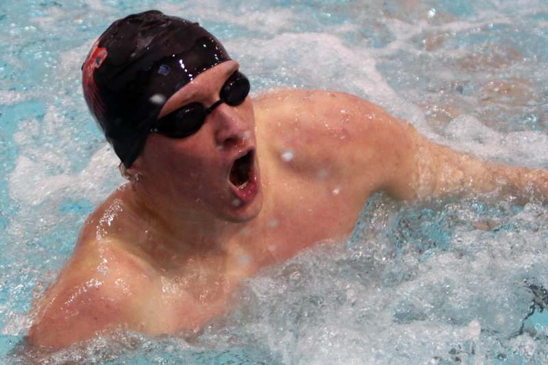 a man in a swimming cap and goggles