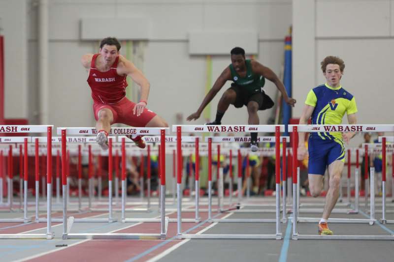 a group of people jumping over hurdles