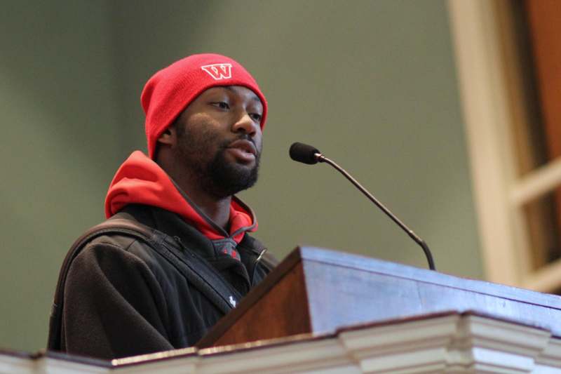 a man in a red hat at a podium