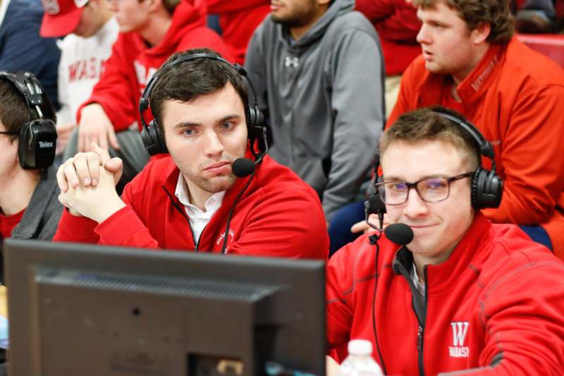 a group of men wearing red jackets and headsets