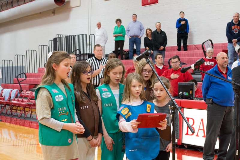 a group of girls singing in a gymnasium