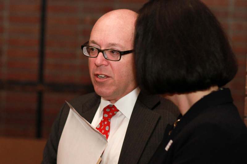 a man in a suit and tie talking to a woman
