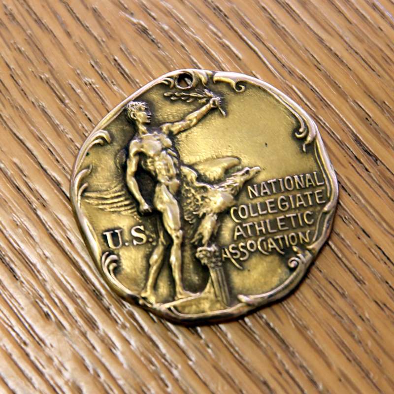 a gold coin with a man holding a torch