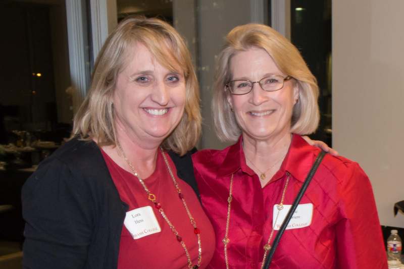 a couple of women wearing name tags
