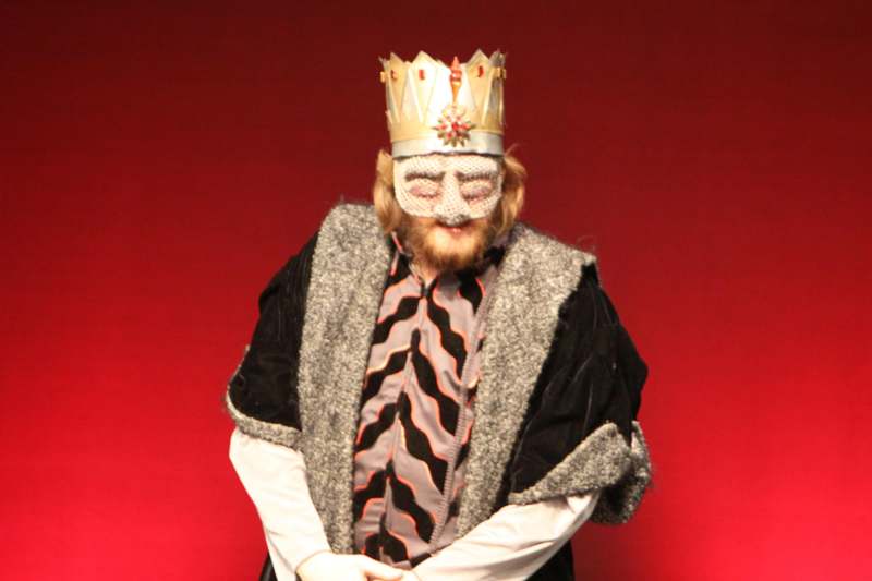 a man wearing a crown and mask