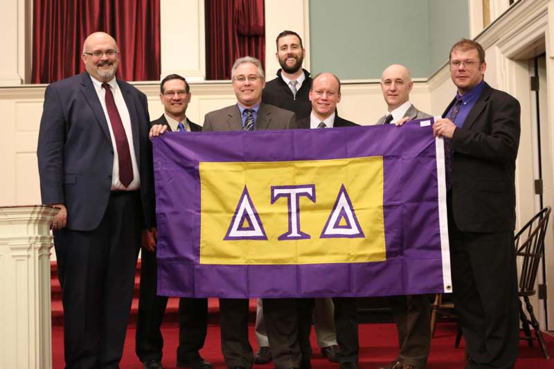 a group of men holding a flag