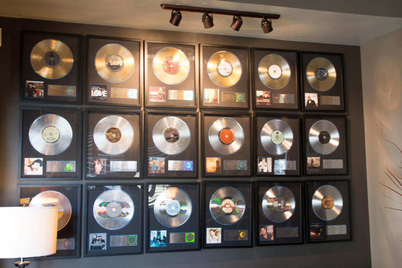 a wall with many silver and gold records
