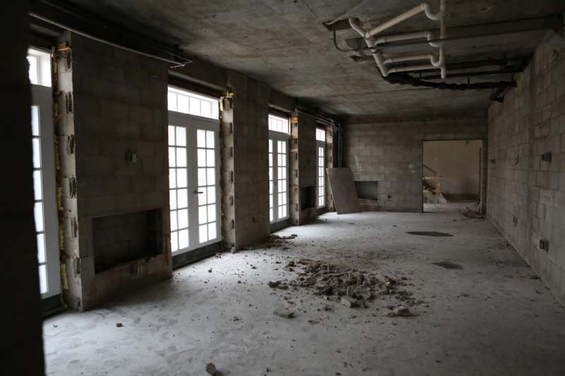 a room with concrete walls and windows