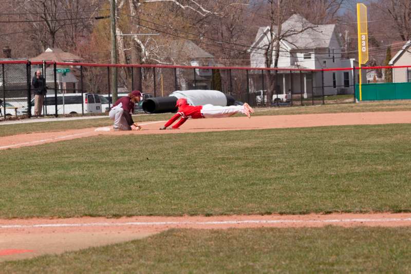 a baseball player diving into the ground