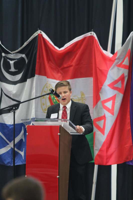 a boy speaking at a podium