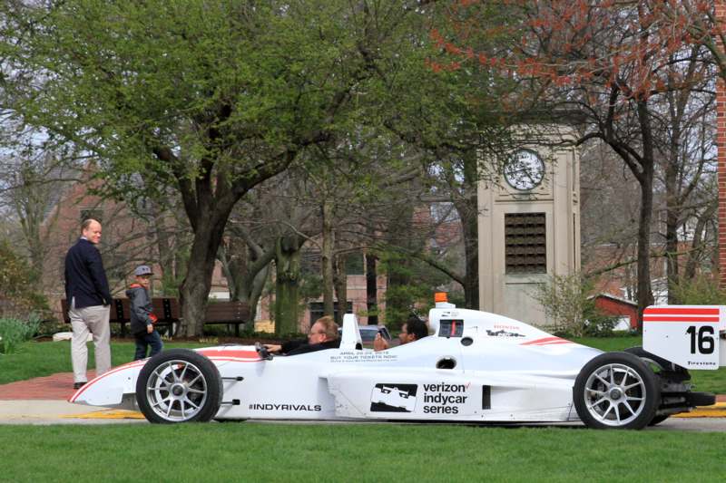 a white race car with people in it