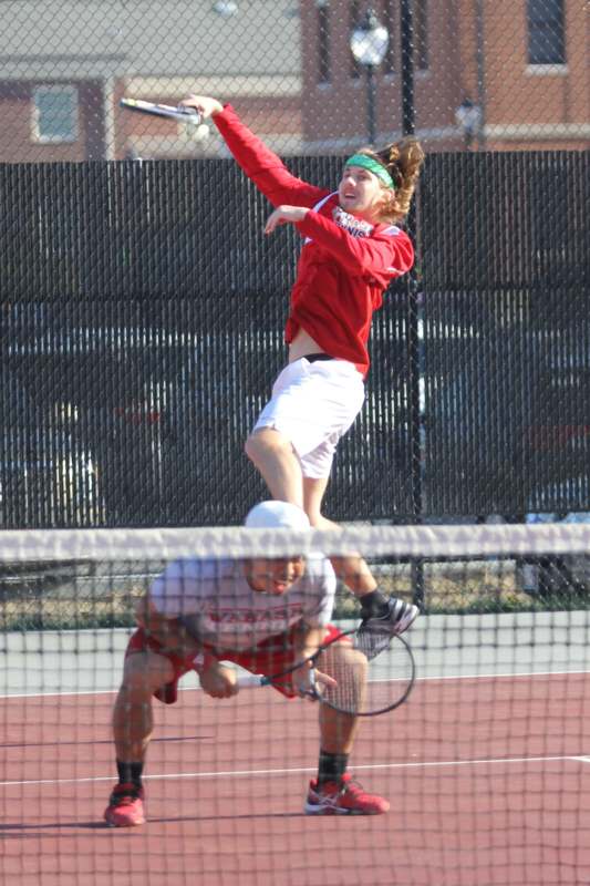 a man jumping over a tennis ball