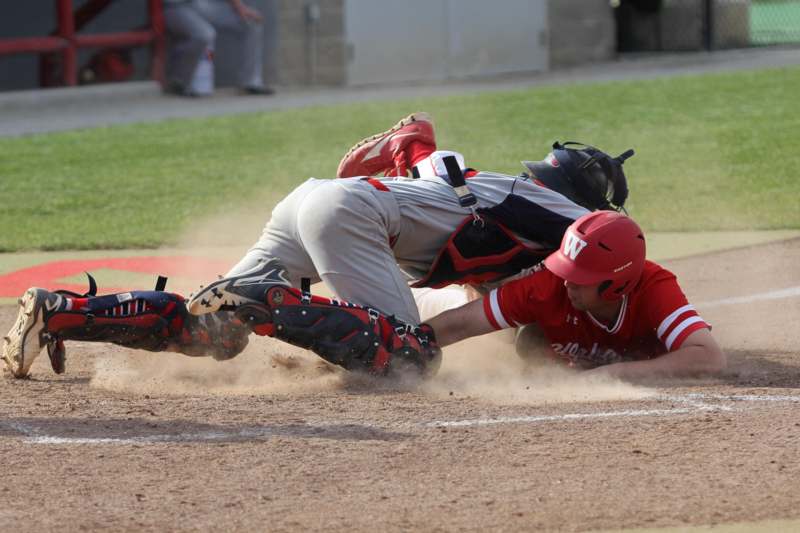 a baseball player sliding into home plate