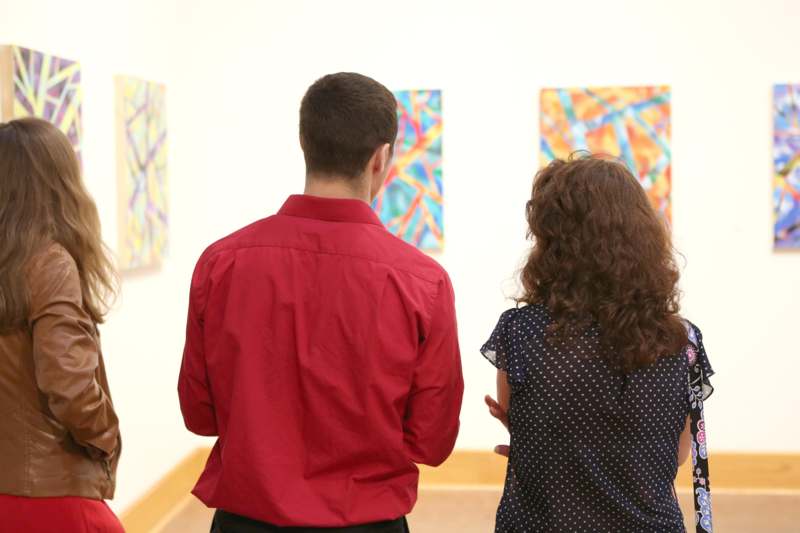 a man and woman looking at art
