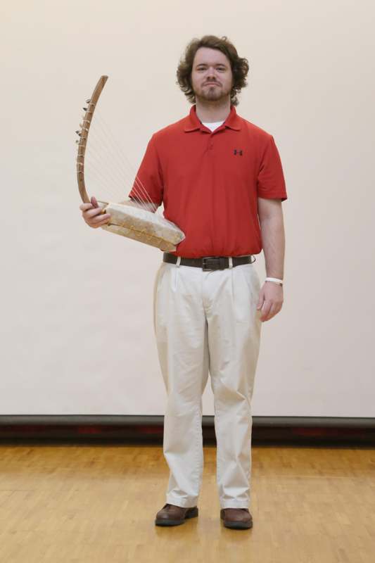 a man holding a harp