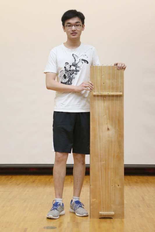 a man holding a wooden instrument