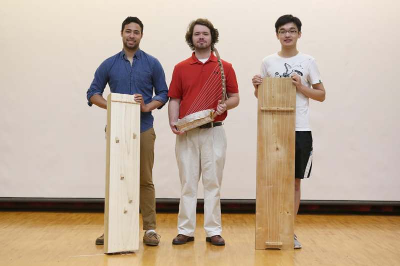 a group of men holding wooden planks