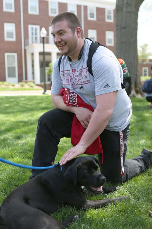 a man petting a dog on a leash