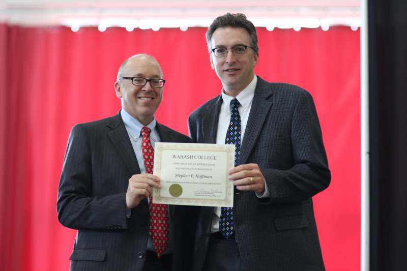 two men holding a certificate