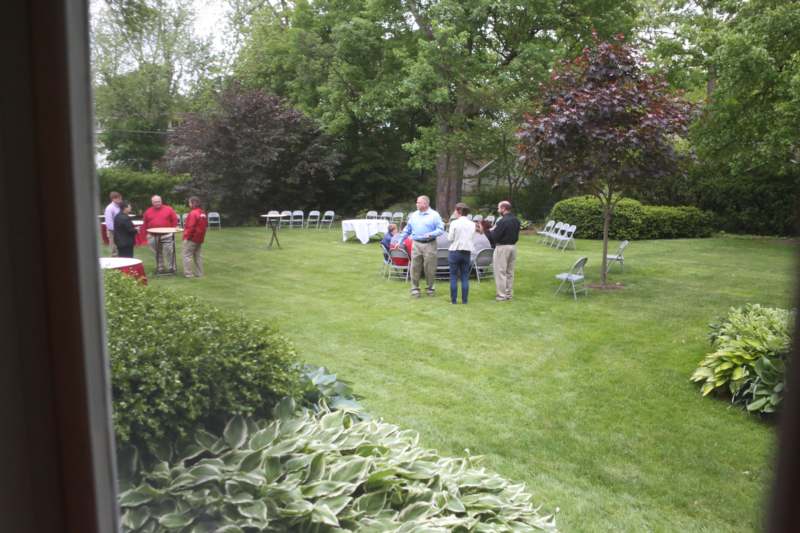 a group of people standing in a lawn